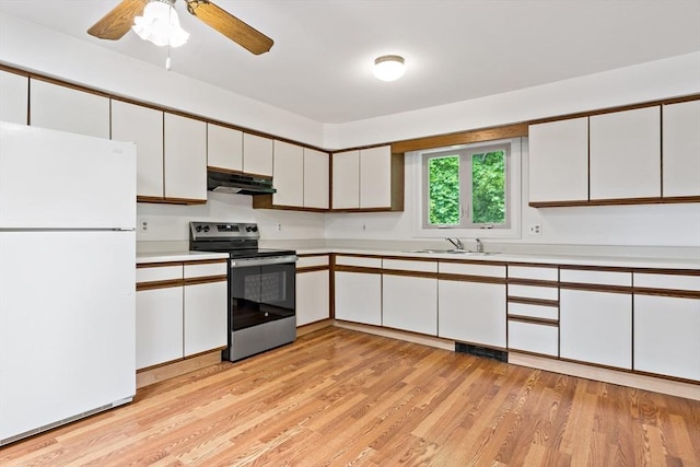 43 Water St, Freetown, MA 02702 - kitchen with freestanding refrigerator, electric range, under cabinet range hood, light countertops, and white cabinets