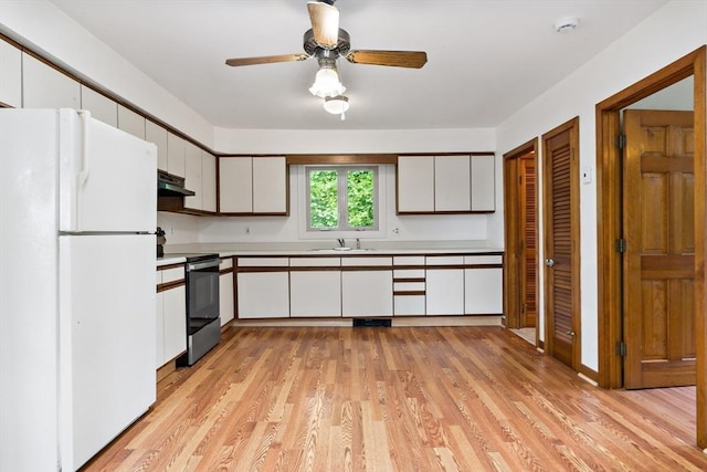 43 Water St, Freetown, MA 02702 - kitchen with freestanding refrigerator, under cabinet range hood, a sink, stainless steel electric range, and light countertops