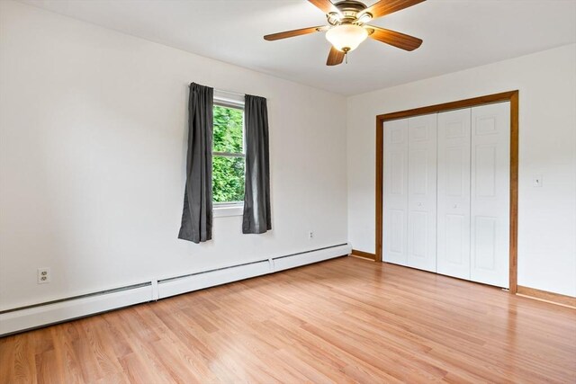 43 Water St, Freetown, MA 02702 - unfurnished bedroom with light wood-type flooring, a baseboard heating unit, baseboards, a closet, and a ceiling fan