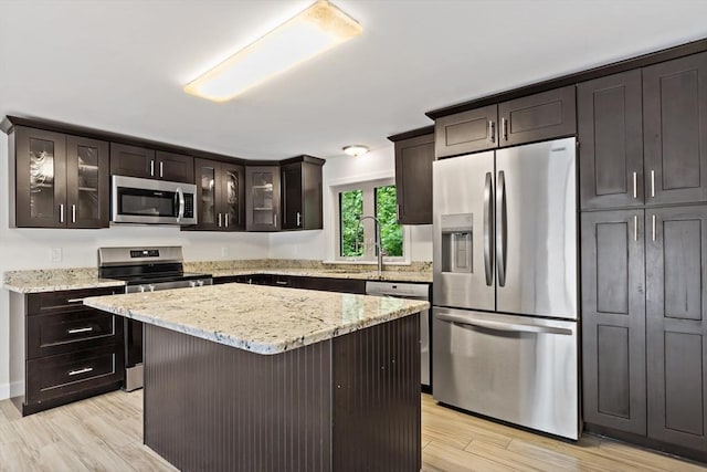 43 Water St, Freetown, MA 02702 - kitchen with stainless steel appliances, a sink, light wood finished floors, and glass insert cabinets
