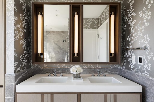 bathroom with a shower with door and vanity