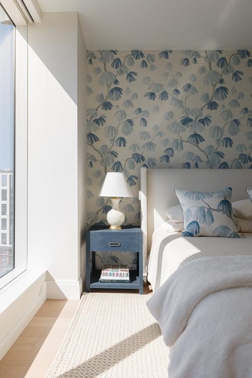 bedroom featuring multiple windows and light wood-type flooring