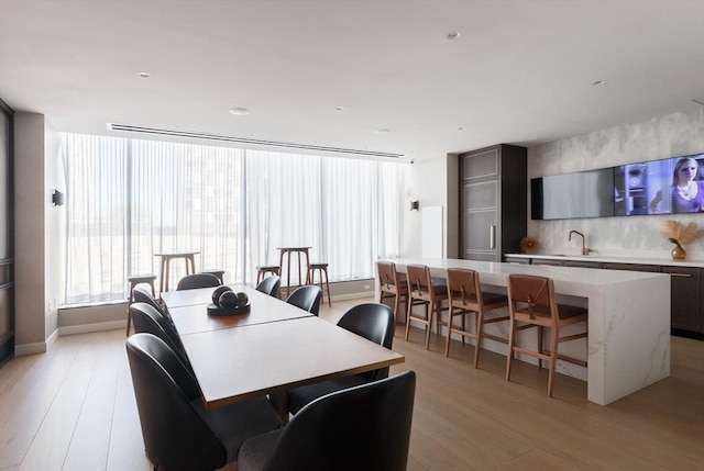 dining area featuring sink and light hardwood / wood-style floors