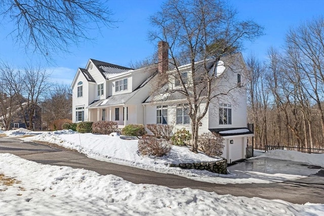 traditional home with a garage and a chimney