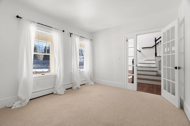 unfurnished bedroom featuring carpet, baseboards, and french doors