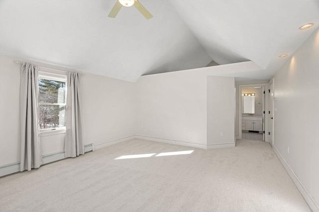 carpeted spare room with baseboards, lofted ceiling, recessed lighting, a ceiling fan, and a baseboard radiator