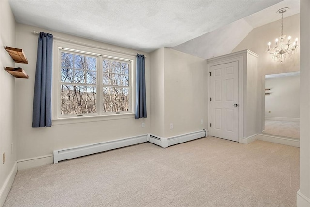 interior space featuring light carpet, a notable chandelier, a textured ceiling, and baseboards