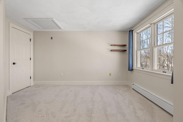 unfurnished room with a textured ceiling, baseboards, baseboard heating, and carpet