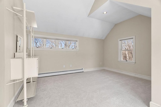 bonus room featuring a baseboard heating unit, lofted ceiling, carpet, and baseboards