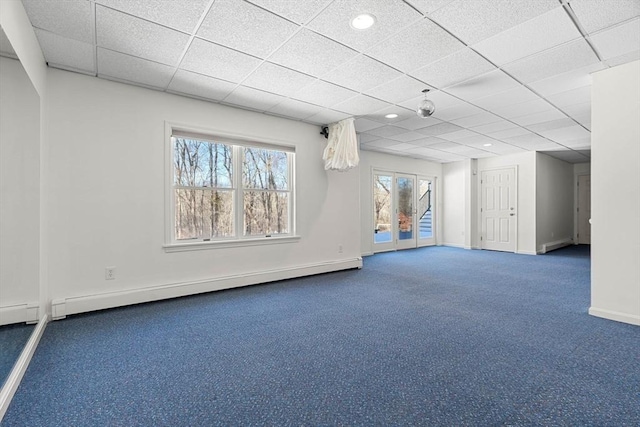 unfurnished room with baseboards, carpet floors, a baseboard radiator, recessed lighting, and a drop ceiling