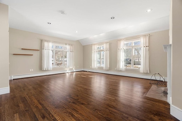 unfurnished living room with a baseboard heating unit, lofted ceiling, wood finished floors, and baseboards