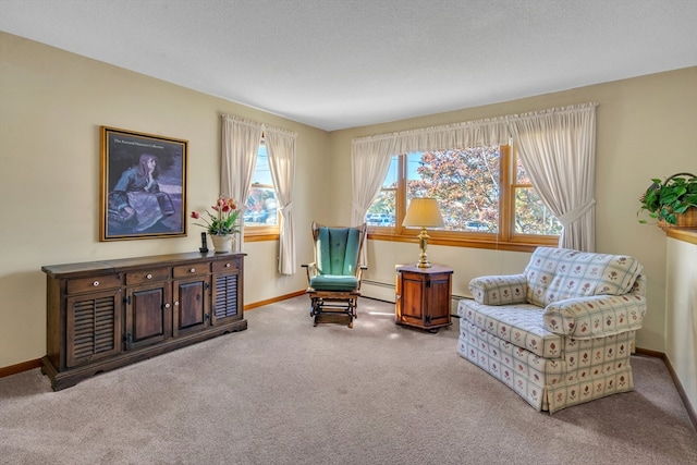 sitting room featuring a baseboard radiator, a textured ceiling, and carpet floors