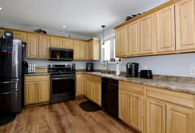 kitchen featuring sink, dark wood-type flooring, appliances with stainless steel finishes, decorative light fixtures, and light brown cabinets