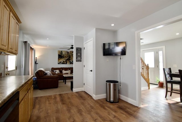 living room featuring dark wood-type flooring and ceiling fan