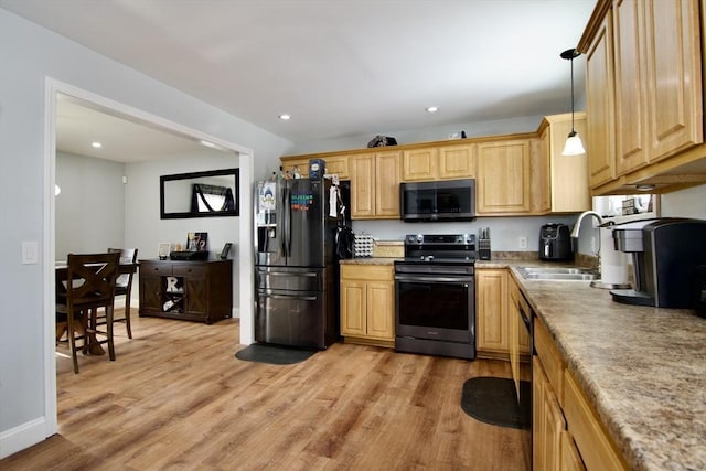 kitchen featuring sink, black refrigerator with ice dispenser, stainless steel electric range, light wood-type flooring, and pendant lighting