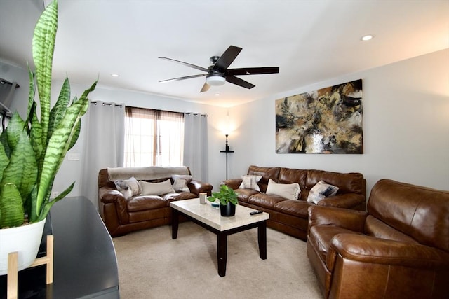 carpeted living room featuring ceiling fan