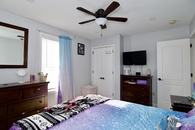 bedroom featuring ceiling fan and a closet