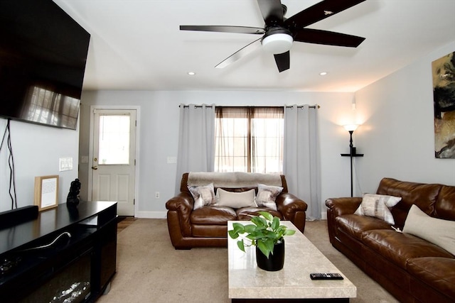 carpeted living room featuring ceiling fan