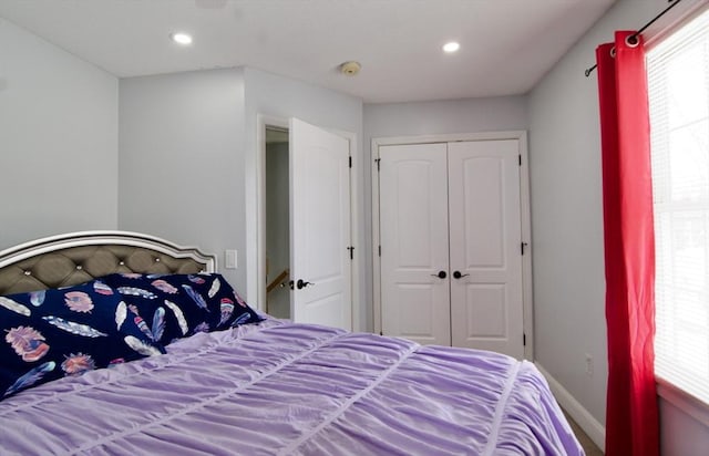 bedroom featuring a closet and multiple windows