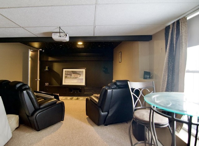 home theater room featuring a paneled ceiling and carpet