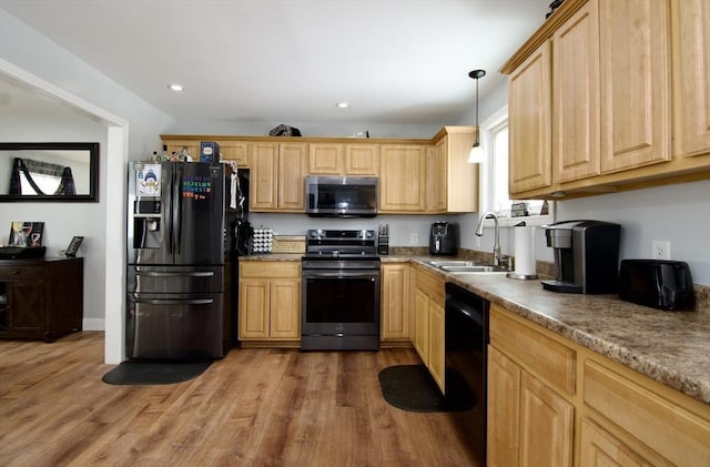 kitchen with dark hardwood / wood-style floors, sink, hanging light fixtures, and black appliances