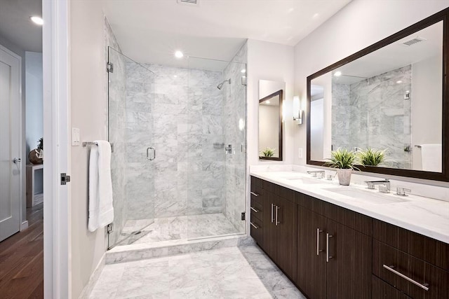 580 Washington St Unit 10F, Boston, MA 02111 - full bathroom with a marble finish shower, double vanity, and recessed lighting