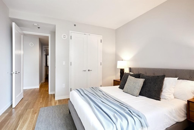 580 Washington St Unit 10F, Boston, MA 02111 - bedroom with light wood-style flooring and a closet