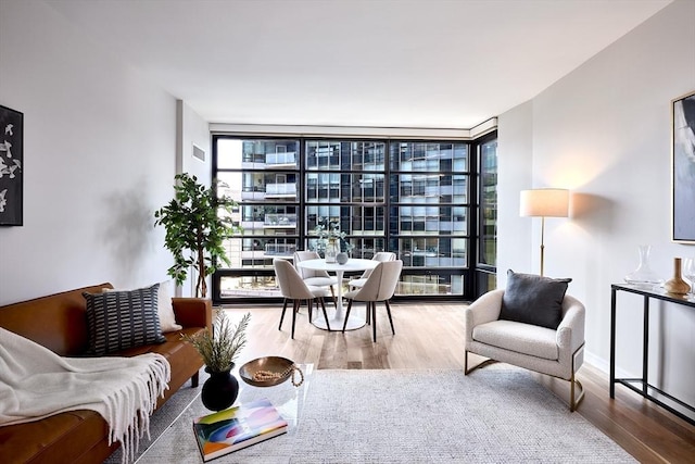 580 Washington St Unit 10F, Boston, MA 02111 - living area featuring floor to ceiling windows and wood finished floors