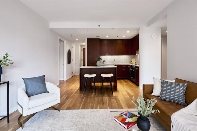 580 Washington St Unit 10F, Boston, MA 02111 - living room featuring light wood-style floors and recessed lighting
