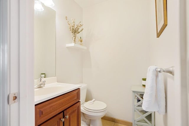 bathroom featuring vanity, tile patterned flooring, and toilet