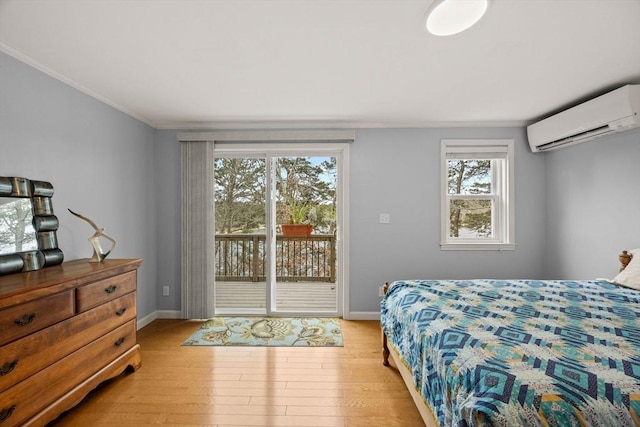 bedroom featuring light hardwood / wood-style flooring, multiple windows, access to outside, and a wall mounted AC