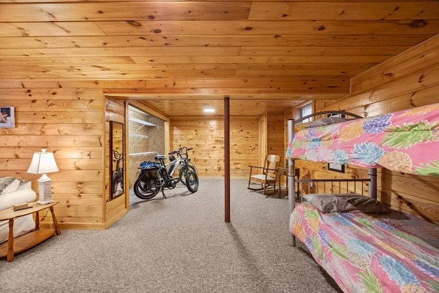 carpeted bedroom with wooden walls and wood ceiling