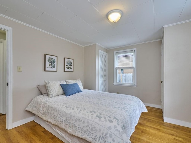 440 Forest St, Waltham, MA 02452 - bedroom featuring baseboards, light wood-style flooring, ornamental molding, and a closet