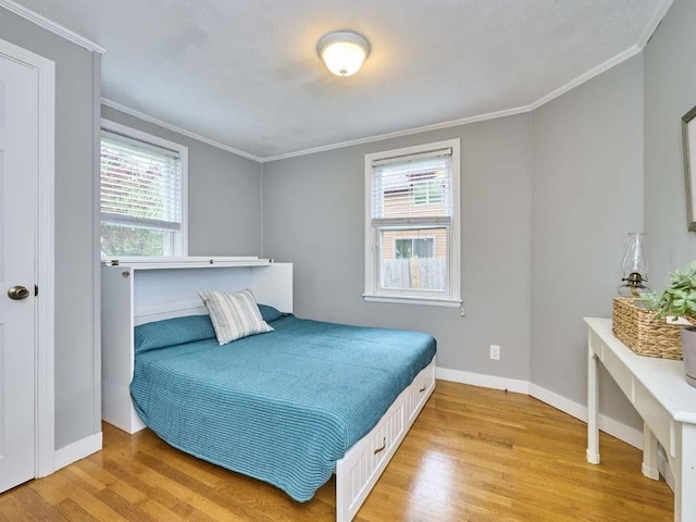 440 Forest St, Waltham, MA 02452 - bedroom with light wood-style flooring, baseboards, and ornamental molding