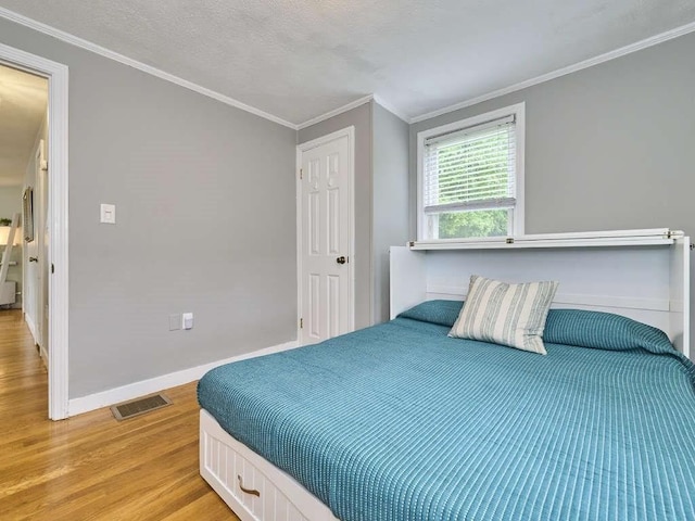 440 Forest St, Waltham, MA 02452 - bedroom with light wood-type flooring, ornamental molding, and baseboards