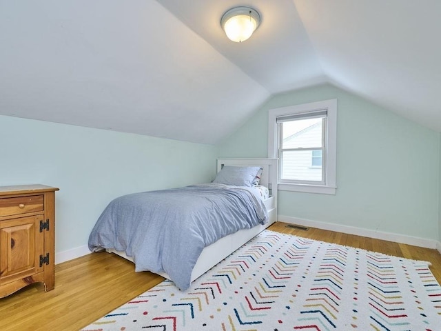 440 Forest St, Waltham, MA 02452 - bedroom featuring light wood-type flooring, lofted ceiling, and baseboards