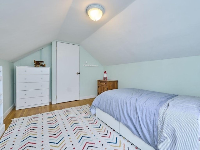 440 Forest St, Waltham, MA 02452 - bedroom featuring wood finished floors, vaulted ceiling, and baseboards