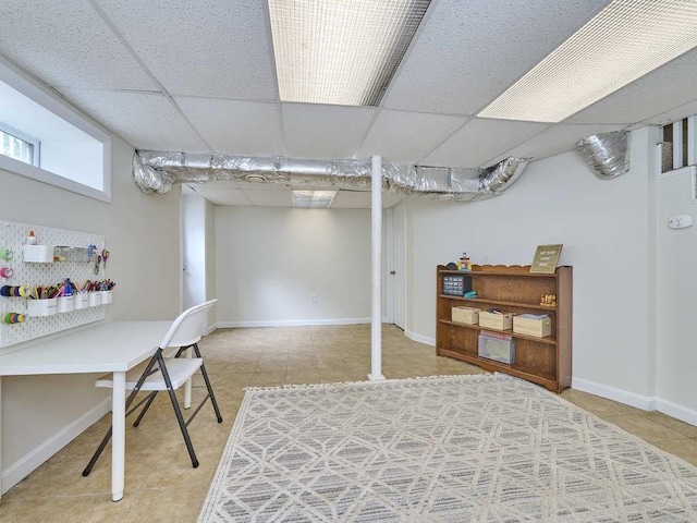 440 Forest St, Waltham, MA 02452 - basement with tile patterned floors, a paneled ceiling, and baseboards