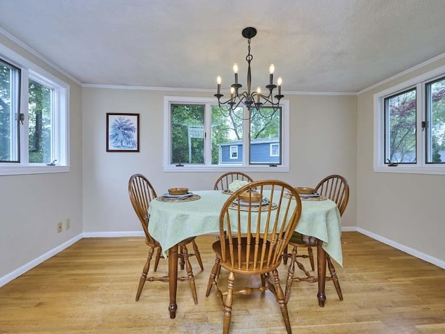 440 Forest St, Waltham, MA 02452 - dining room featuring healthy amount of natural light, light wood-style flooring, baseboards, and crown molding