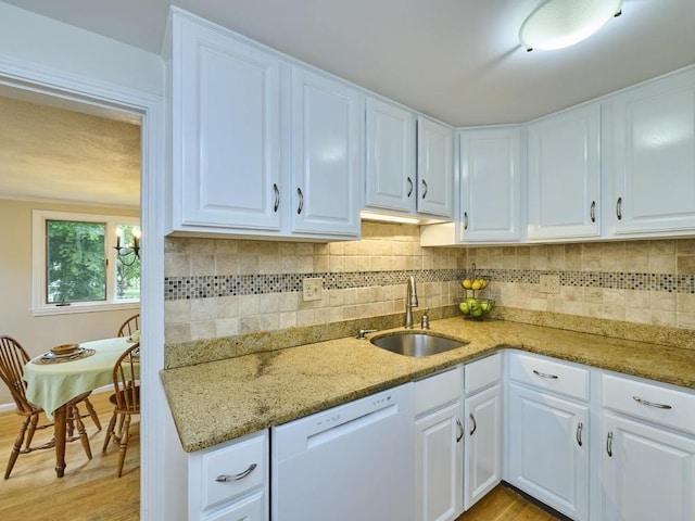 440 Forest St, Waltham, MA 02452 - kitchen featuring white dishwasher, a sink, light wood finished floors, and light stone countertops