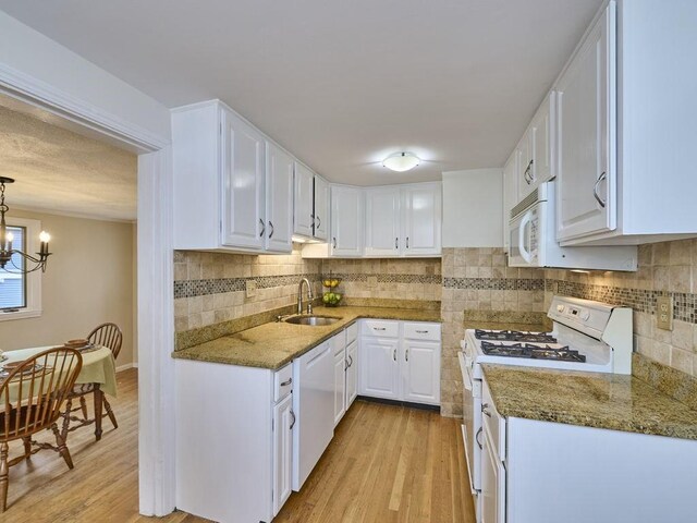 440 Forest St, Waltham, MA 02452 - kitchen with white appliances, a sink, light wood-style flooring, and white cabinetry