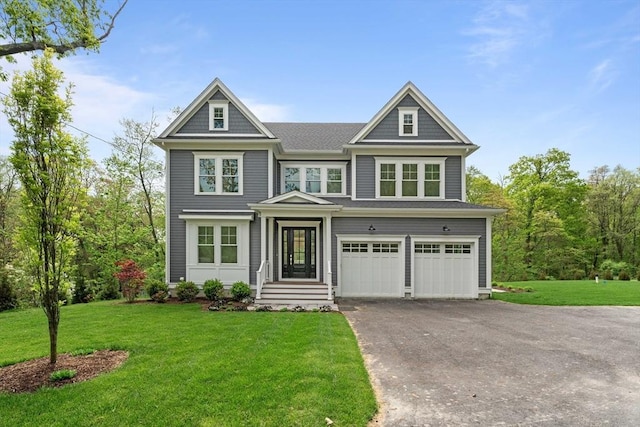 view of front of house with a garage and a front lawn