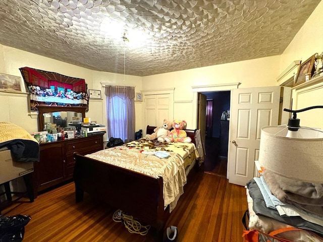 bedroom with dark wood-style floors