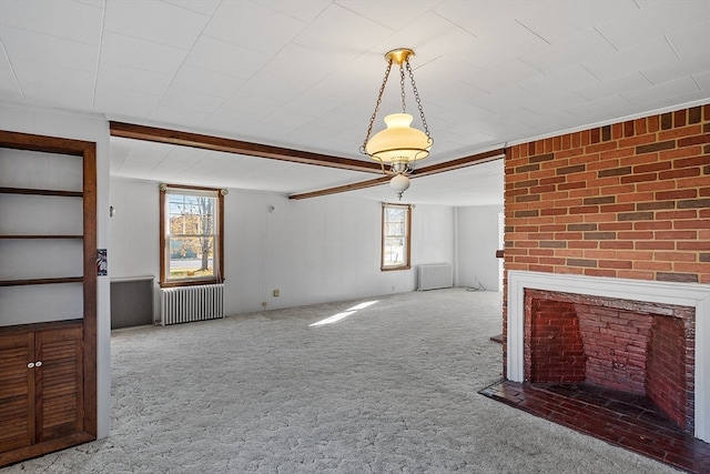 unfurnished living room featuring a fireplace, light carpet, and radiator heating unit