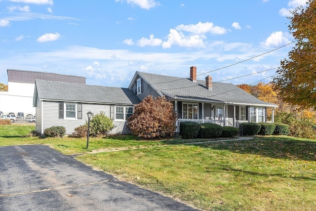 single story home with a front yard and a porch