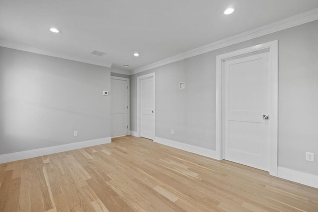 spare room featuring light hardwood / wood-style flooring and ornamental molding