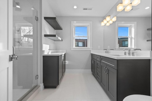 bathroom with plenty of natural light, vanity, and walk in shower