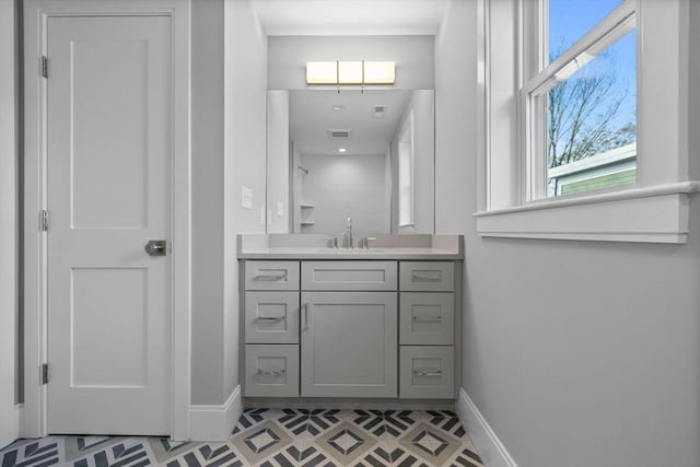 bathroom with tile patterned flooring and vanity