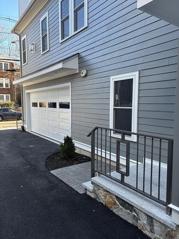 doorway to property with a garage