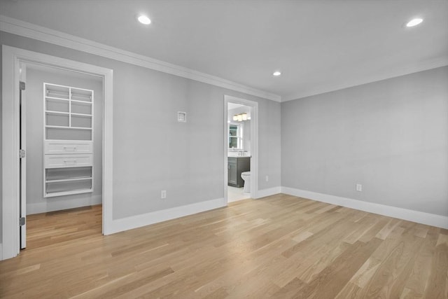 unfurnished room with crown molding and light hardwood / wood-style flooring